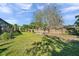 A sprawling backyard features lush green grass, shade trees, and privacy fence, creating a serene outdoor space at 3208 Stevenson St, Plant City, FL 33566