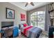 This bedroom features a ceiling fan, large window with great view, and a nice desk to study at 3208 Stevenson St, Plant City, FL 33566