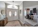 Elegant foyer with a double front door, chandelier, and an adjacent home office at 3208 Stevenson St, Plant City, FL 33566