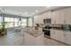 Bright kitchen with stainless appliances, white cabinetry, granite countertops, and a kitchen island at 3208 Stevenson St, Plant City, FL 33566