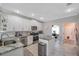 Bright, white kitchen with modern appliances, island, and ample storage space at 3208 Stevenson St, Plant City, FL 33566
