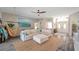 Inviting living room featuring a large sectional sofa, ceiling fan, and modern décor at 3208 Stevenson St, Plant City, FL 33566