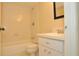 Bathroom with a tiled shower and tub with a vanity with white countertops at 3358 Mermoor Dr # 2106, Palm Harbor, FL 34685