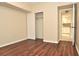 Bedroom with laminate flooring and a closet, showing view into the kitchen at 3358 Mermoor Dr # 2106, Palm Harbor, FL 34685