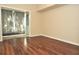 Bright bedroom with laminate floors leads to a sliding glass door to patio at 3358 Mermoor Dr # 2106, Palm Harbor, FL 34685