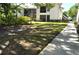 Exterior view of condo buildings with well maintained lawns and mature trees at 3358 Mermoor Dr # 2106, Palm Harbor, FL 34685