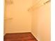 Walk-in closet featuring hardwood floors and wire shelving providing ample storage space at 3358 Mermoor Dr # 2106, Palm Harbor, FL 34685