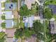 Aerial view of a residential neighborhood with mature trees and well-maintained lawns, featuring a home with solar panels at 3612 Sugar Loaf Ln, Valrico, FL 33596