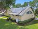 View of home's exterior, showcasing solar panels, landscaping, and a well-maintained yard at 3612 Sugar Loaf Ln, Valrico, FL 33596