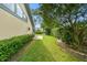 The verdant backyard, adorned with mature trees and lush greenery, adds to the exterior beauty of the home at 3612 Sugar Loaf Ln, Valrico, FL 33596