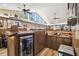 Cozy bar area featuring wood paneling, cabinetry, under-counter refrigerator, and sink at 3612 Sugar Loaf Ln, Valrico, FL 33596