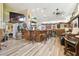 Entertainment area featuring a wood-paneled bar, ample seating, and a built-in mini-refrigerator at 3612 Sugar Loaf Ln, Valrico, FL 33596