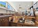 Spacious wet bar area with wooden cabinets and countertop and lots of natural light at 3612 Sugar Loaf Ln, Valrico, FL 33596