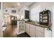 Stylish wet bar featuring modern cabinets, glass shelving, and a convenient sink for beverage preparation at 3612 Sugar Loaf Ln, Valrico, FL 33596