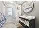 Bathroom featuring modern vanity with open towel storage and a shower/tub with a curtain at 3612 Sugar Loaf Ln, Valrico, FL 33596