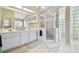 Bathroom featuring a double vanity, glass block window, and walk-in shower at 3612 Sugar Loaf Ln, Valrico, FL 33596