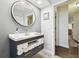 Bathroom featuring a modern vanity with open towel storage and an entry to a hallway at 3612 Sugar Loaf Ln, Valrico, FL 33596