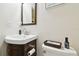 Cozy powder room featuring a corner sink, elegant fixtures, and stylish accents at 3612 Sugar Loaf Ln, Valrico, FL 33596