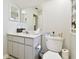 Bathroom featuring tiled floors, a neutral vanity, and a toilet with an open shelving at 3612 Sugar Loaf Ln, Valrico, FL 33596