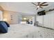 Bright bedroom featuring a ceiling fan, large bed, and sliding glass doors leading to the pool at 3612 Sugar Loaf Ln, Valrico, FL 33596