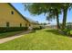 A lush green lawn, mature trees, and a paved walkway enhance the exterior appeal of this home at 3612 Sugar Loaf Ln, Valrico, FL 33596