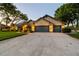 Beautifully landscaped front yard leading to a charming house with a spacious three-car garage at 3612 Sugar Loaf Ln, Valrico, FL 33596