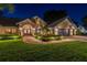 Beautiful home featuring arched entryway, complemented by lush landscaping and an attached three car garage at 3612 Sugar Loaf Ln, Valrico, FL 33596