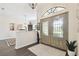 Foyer showcasing a decorative glass front door, chandelier, and half wall looking into living area at 3612 Sugar Loaf Ln, Valrico, FL 33596