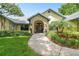 Charming front entrance with brick archway and lush landscaping at 3612 Sugar Loaf Ln, Valrico, FL 33596