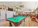 Game room with a pool table, poker table, bar, and lounge area for entertaining at 3612 Sugar Loaf Ln, Valrico, FL 33596