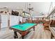 Well-lit game room with a pool table, bar, vaulted ceilings, and ample space for recreation at 3612 Sugar Loaf Ln, Valrico, FL 33596