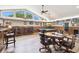 Spacious game room with a pool table, bar area, high windows and a ceiling fan at 3612 Sugar Loaf Ln, Valrico, FL 33596
