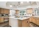 Bright kitchen features wood cabinets, an island cooktop and stainless steel appliances at 3612 Sugar Loaf Ln, Valrico, FL 33596