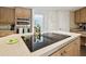 Bright kitchen features wood cabinets, an island cooktop and stainless steel appliances at 3612 Sugar Loaf Ln, Valrico, FL 33596