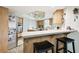 Eat-in kitchen featuring modern appliances, a breakfast bar, ample storage, and light wood cabinets at 3612 Sugar Loaf Ln, Valrico, FL 33596