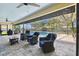 Covered lanai with comfortable seating, grill, and screened pool at 3612 Sugar Loaf Ln, Valrico, FL 33596