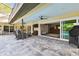 Spacious screened lanai with seating area and a view of the pool and backyard at 3612 Sugar Loaf Ln, Valrico, FL 33596
