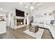 This living room features a fireplace, luxury vinyl floors and neutral paint at 3612 Sugar Loaf Ln, Valrico, FL 33596