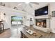 Inviting living room features a stone fireplace, sliding glass doors to the pool area, and bright natural light at 3612 Sugar Loaf Ln, Valrico, FL 33596