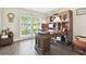 Office with wood floors, a large window and a wood desk with hutch at 3612 Sugar Loaf Ln, Valrico, FL 33596