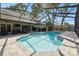 Spacious lanai with a screened-in pool, outdoor seating, and lush landscaping at 3612 Sugar Loaf Ln, Valrico, FL 33596