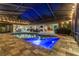 Inviting screened-in pool area featuring a large pool, comfortable patio furniture, and ambient string lights at 3612 Sugar Loaf Ln, Valrico, FL 33596