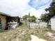 Backyard featuring a shed, some trees, partial white fencing, and plenty of potential at 4116 Cardoon Dr, New Port Richey, FL 34653