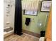 Bathroom featuring a shower with black curtain, neutral tile flooring, and grab bar at 4116 Cardoon Dr, New Port Richey, FL 34653