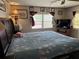 Cozy bedroom with floral bedding, window, and dark wood furniture at 4116 Cardoon Dr, New Port Richey, FL 34653