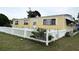 Charming single-story home featuring a white picket fence and well-maintained lawn at 4116 Cardoon Dr, New Port Richey, FL 34653