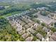 Aerial view of the neighborhood shows the property's location near a pond and commercial areas, with lush tree coverage at 5714 Kingletsound Pl, Lithia, FL 33547