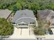 Aerial view of townhome featuring a balcony and tandem two-car garage nestled in a well-maintained neighborhood at 5714 Kingletsound Pl, Lithia, FL 33547