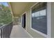 Balcony overlooking a residential street, featuring a black wrought iron railing, and neutral exterior paint at 5714 Kingletsound Pl, Lithia, FL 33547