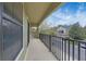 Balcony with a black wrought iron railing overlooking a street of homes and blue sky at 5714 Kingletsound Pl, Lithia, FL 33547